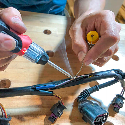action shot of soldering iron mending wires